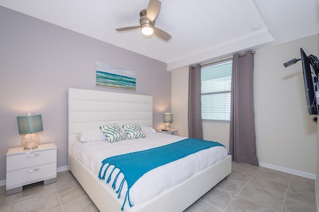 tiled bedroom featuring ceiling fan