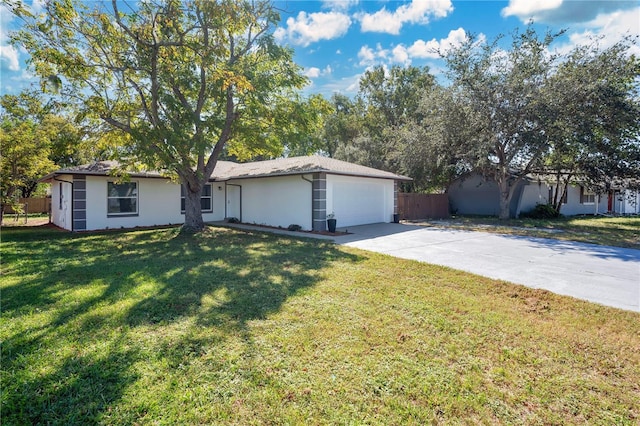 single story home with a garage and a front lawn