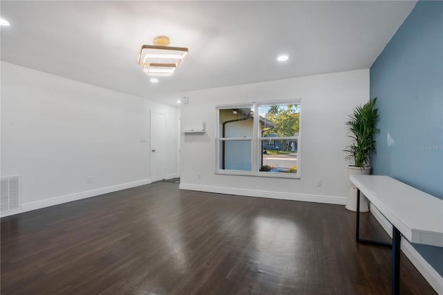 empty room with dark wood-type flooring