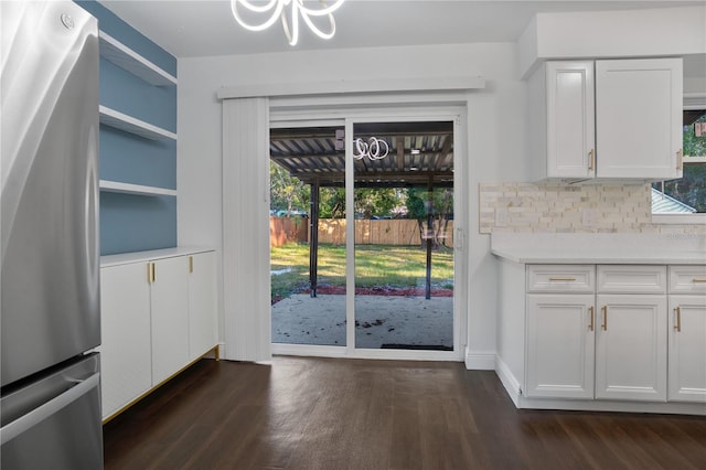 unfurnished dining area featuring a wealth of natural light and dark wood-type flooring