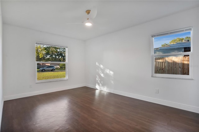 spare room with ceiling fan and dark hardwood / wood-style flooring