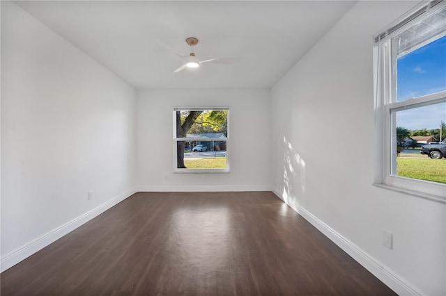 spare room with dark wood-type flooring and ceiling fan