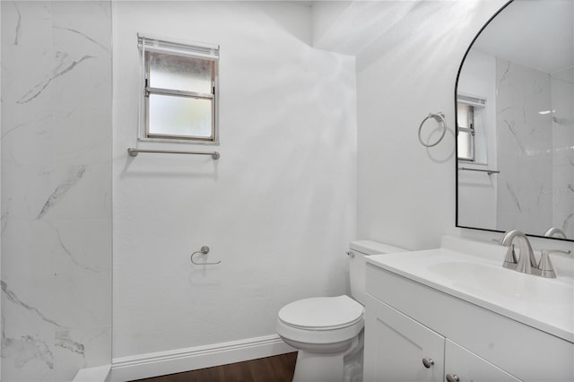 bathroom featuring vanity, toilet, and hardwood / wood-style floors