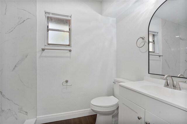 1213 Baranova Rd, Ocoee, FL 34761 - bathroom with vanity, baseboards, toilet, and wood finished floors