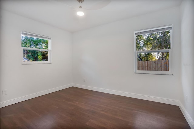 unfurnished room featuring ceiling fan and dark hardwood / wood-style flooring