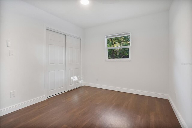 1213 Baranova Rd, Ocoee, FL 34761 - unfurnished bedroom featuring dark wood-type flooring, baseboards, and a closet