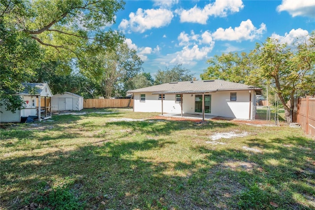 back of house featuring a patio, a storage shed, and a lawn