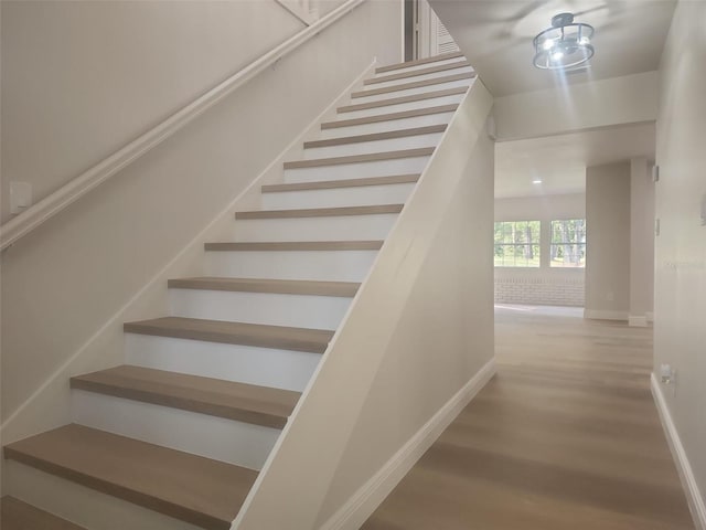 stairs featuring wood-type flooring