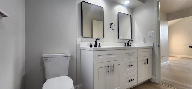 bathroom featuring hardwood / wood-style floors, vanity, and toilet