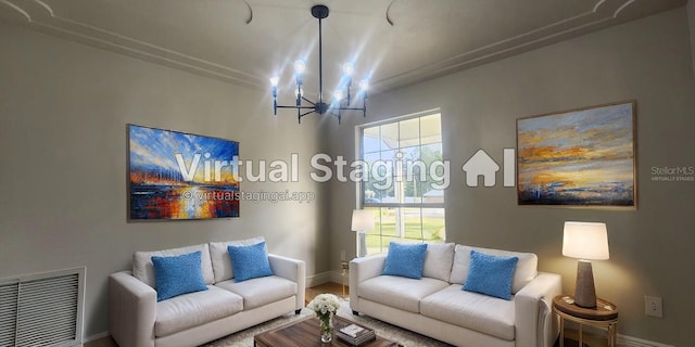 living room with wood-type flooring and an inviting chandelier