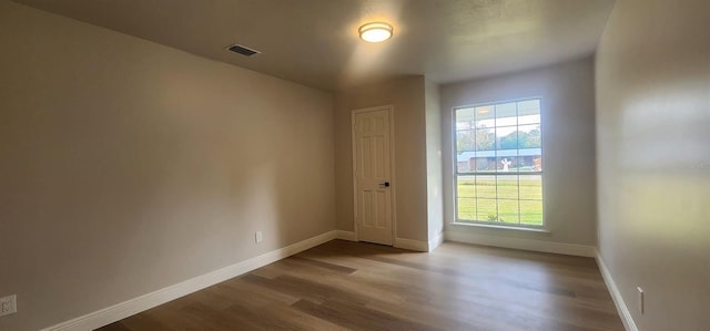 empty room featuring hardwood / wood-style flooring and a wealth of natural light