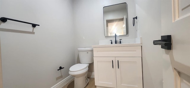 bathroom featuring hardwood / wood-style floors, vanity, and toilet