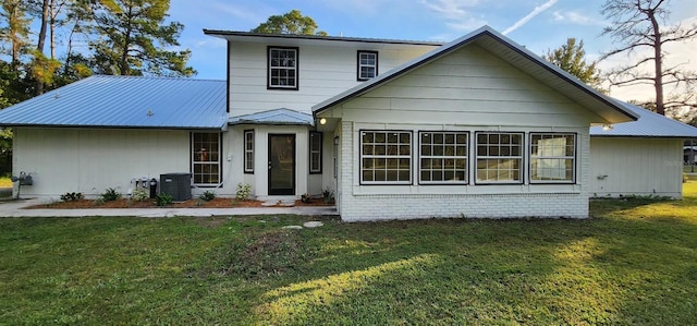 view of front of house featuring a front lawn and central AC unit