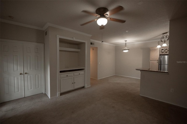 unfurnished living room featuring ornamental molding, light colored carpet, and ceiling fan