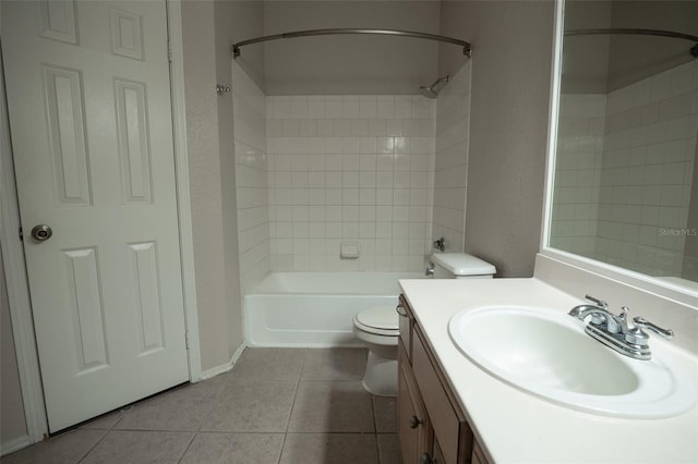 full bathroom with tile patterned flooring, vanity, toilet, and tiled shower / bath