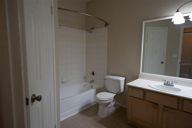 full bathroom featuring tile patterned flooring, vanity, tiled shower / bath combo, and toilet