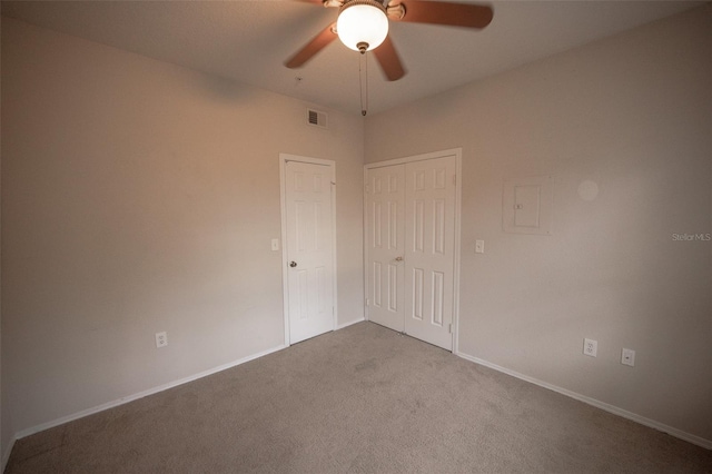 empty room featuring ceiling fan and carpet floors