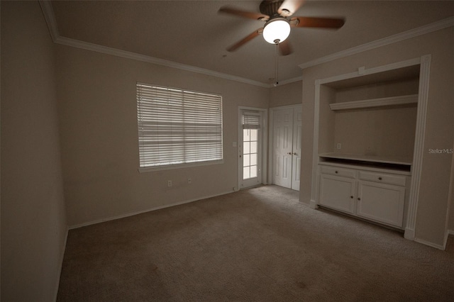 interior space with ceiling fan and crown molding