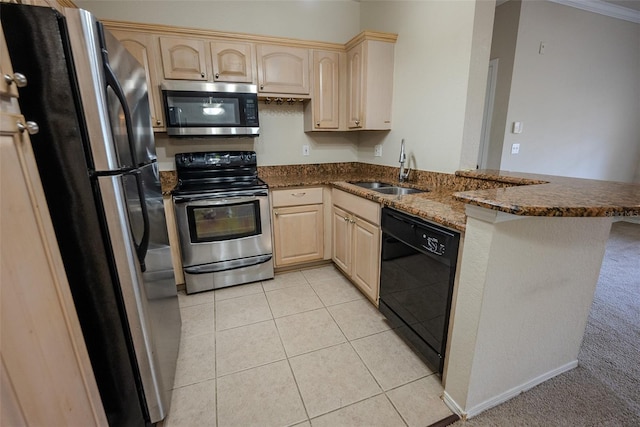 kitchen featuring kitchen peninsula, stainless steel appliances, sink, dark stone countertops, and light brown cabinets