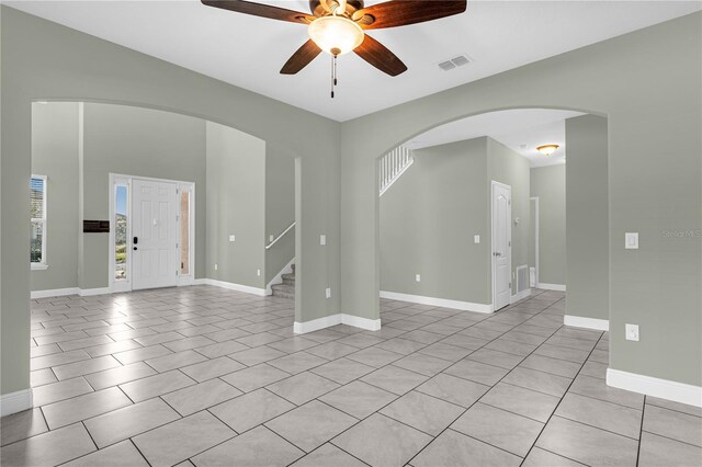 spare room with light tile patterned flooring and ceiling fan