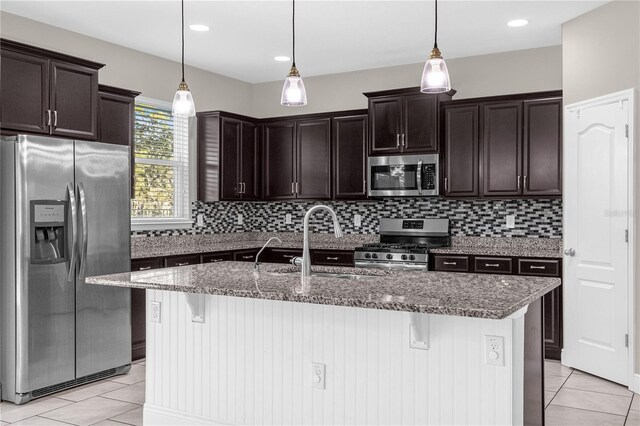 kitchen with dark brown cabinetry, appliances with stainless steel finishes, sink, and hanging light fixtures