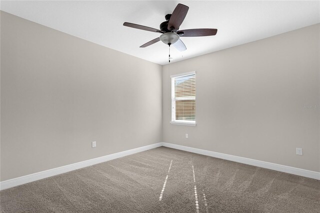 carpeted empty room featuring ceiling fan