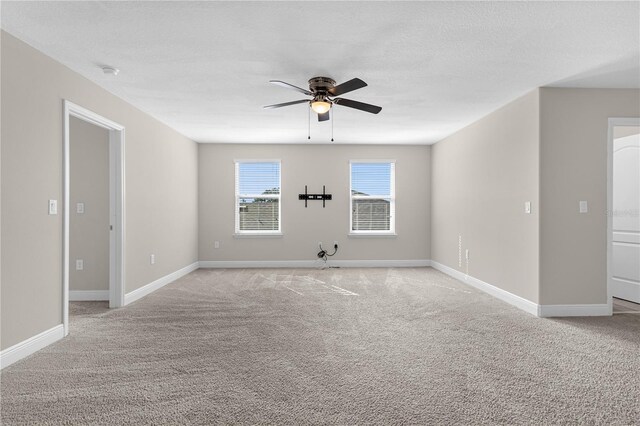 carpeted empty room featuring a textured ceiling and ceiling fan