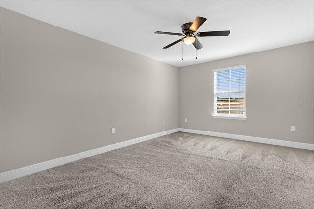 spare room with ceiling fan and carpet floors