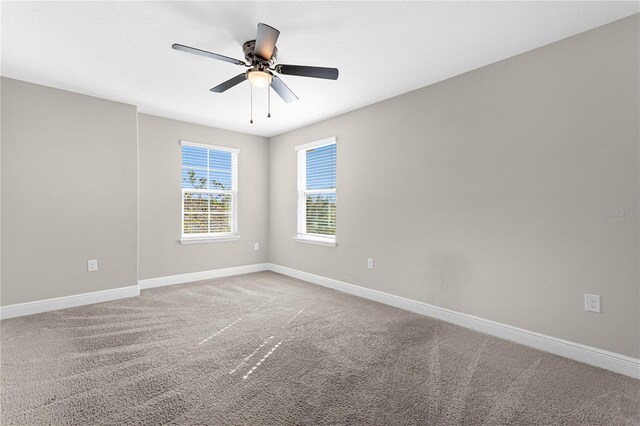 empty room with ceiling fan and carpet flooring