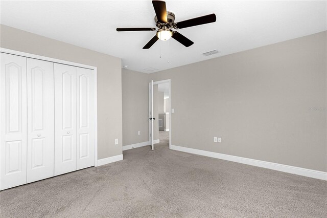 unfurnished bedroom with carpet flooring, a closet, and ceiling fan