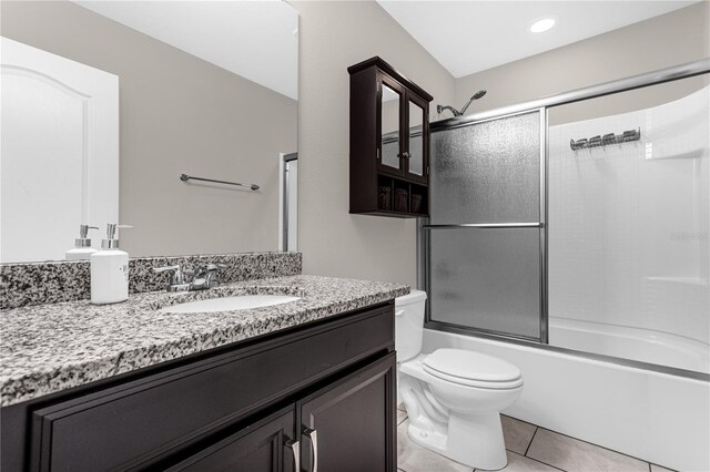 full bathroom featuring toilet, combined bath / shower with glass door, vanity, and tile patterned flooring