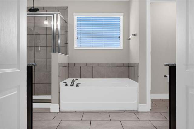 bathroom featuring tile patterned floors and separate shower and tub