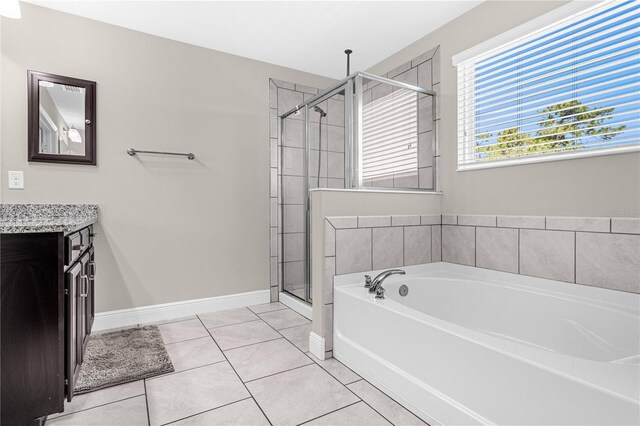 bathroom featuring vanity, tile patterned floors, and plus walk in shower