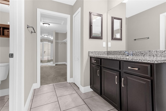 bathroom featuring vanity, toilet, and tile patterned floors