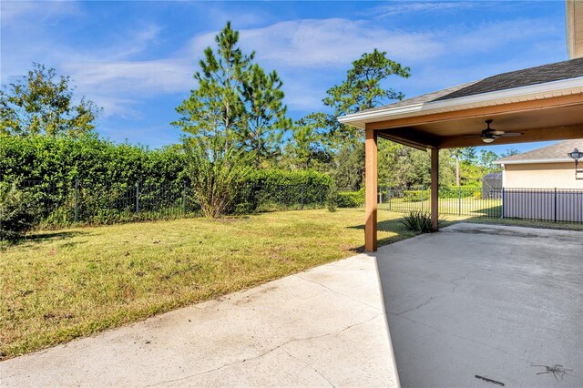 view of yard featuring a patio and ceiling fan