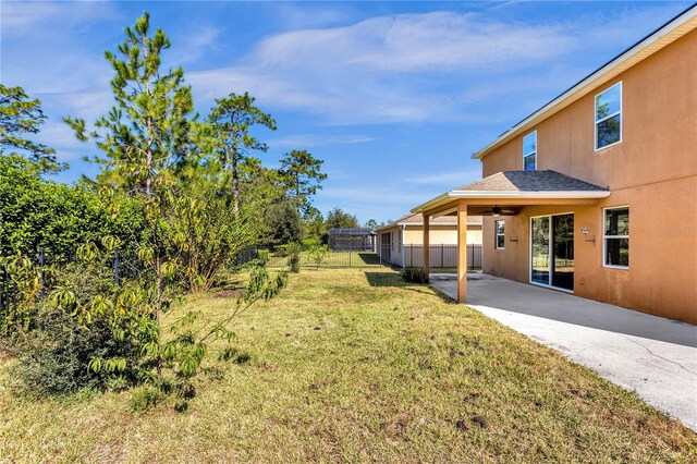 view of yard featuring a patio area and ceiling fan