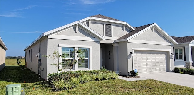 view of front facade with a front yard and a garage