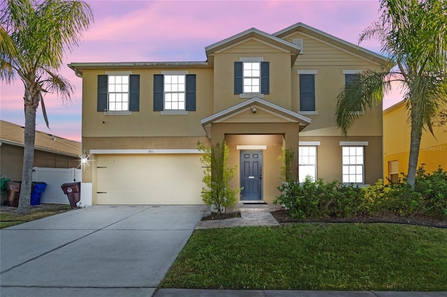 view of front of property featuring a lawn and a garage