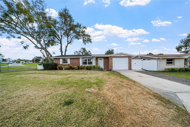 ranch-style home with a front yard and a garage