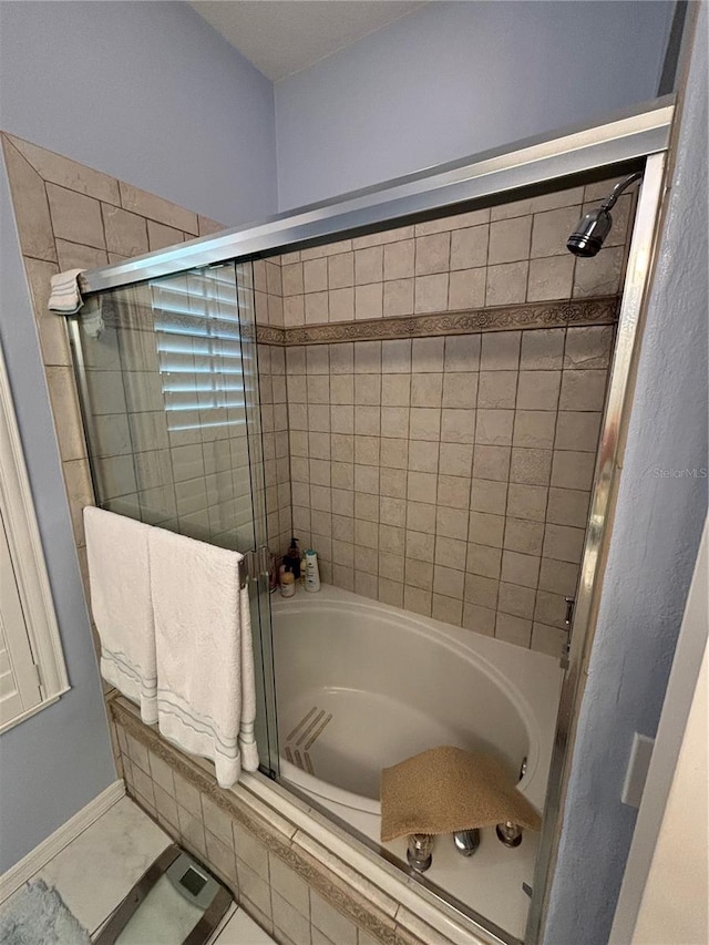 bathroom with shower / bath combination with glass door