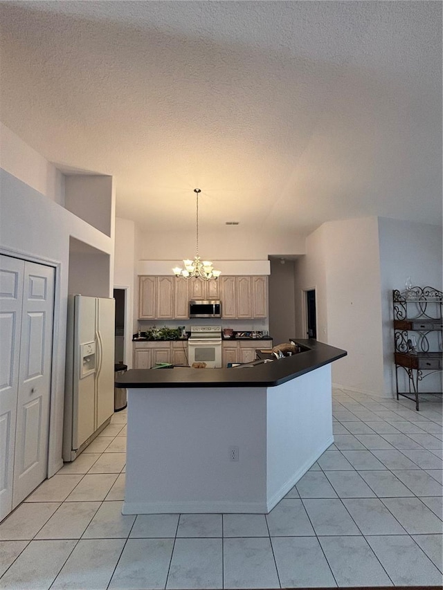 kitchen with light brown cabinetry, white appliances, light tile patterned floors, decorative light fixtures, and a notable chandelier