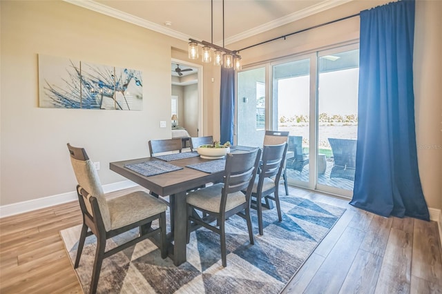 dining space with wood-type flooring and ornamental molding