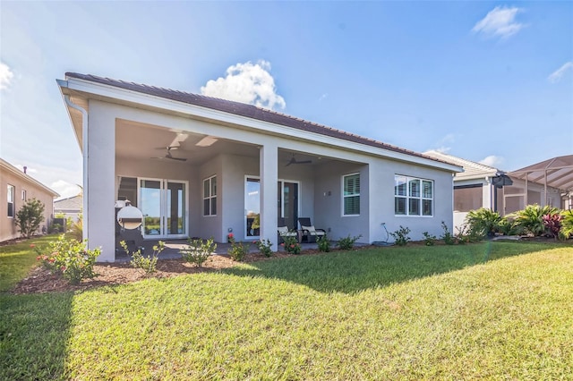 back of house featuring a patio area, a lanai, a lawn, and ceiling fan