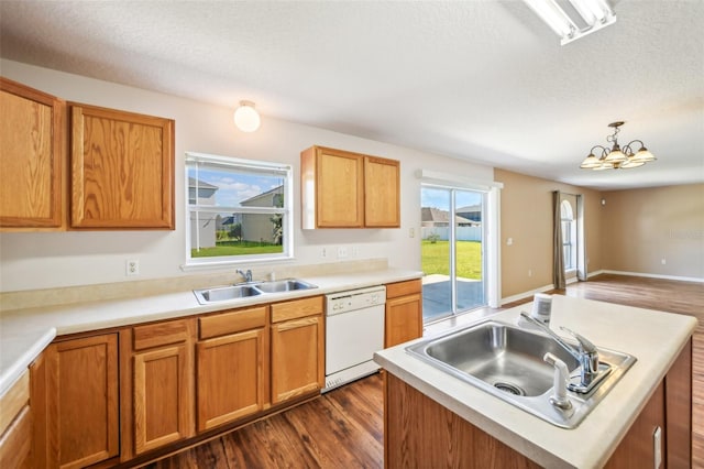 kitchen featuring dishwasher, sink, a center island, a notable chandelier, and dark hardwood / wood-style flooring