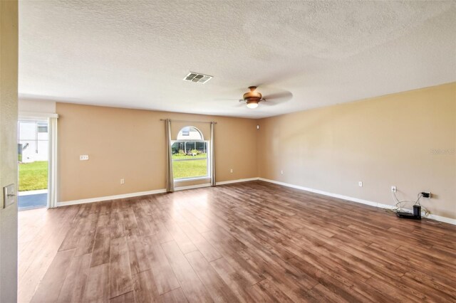 empty room with hardwood / wood-style floors, a textured ceiling, and ceiling fan