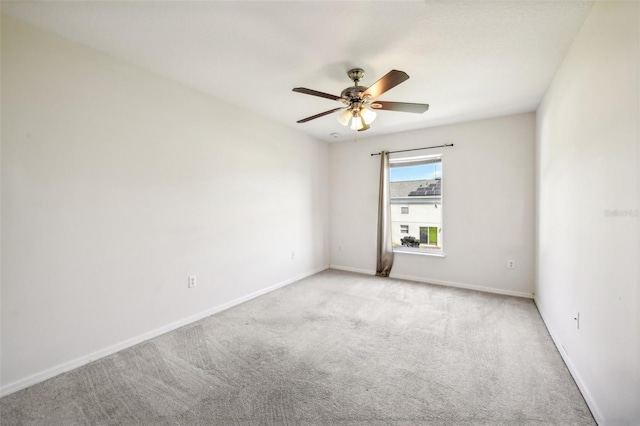 spare room with ceiling fan and light colored carpet