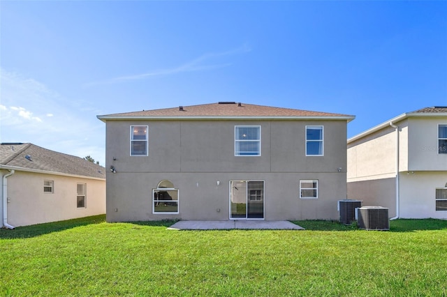 back of house with a patio, a lawn, and central air condition unit