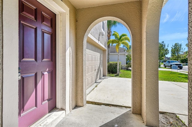 doorway to property with a garage