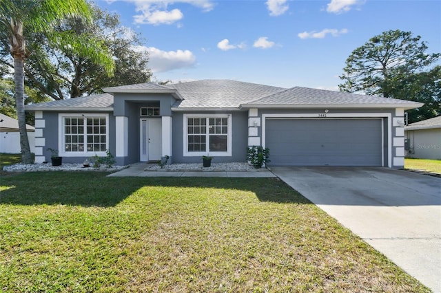 view of front of home with a garage and a front lawn