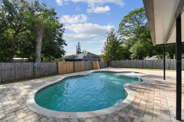 view of swimming pool with pool water feature and a patio area